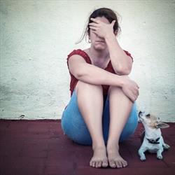 Sad woman with terrier 